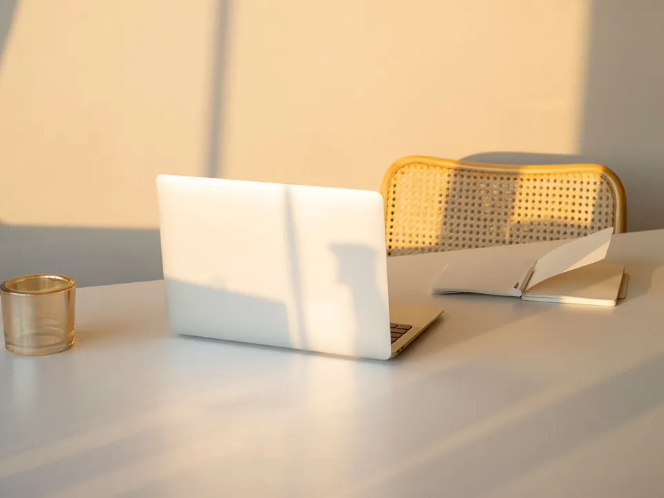 A notebook and laptop arranged for planning and writing