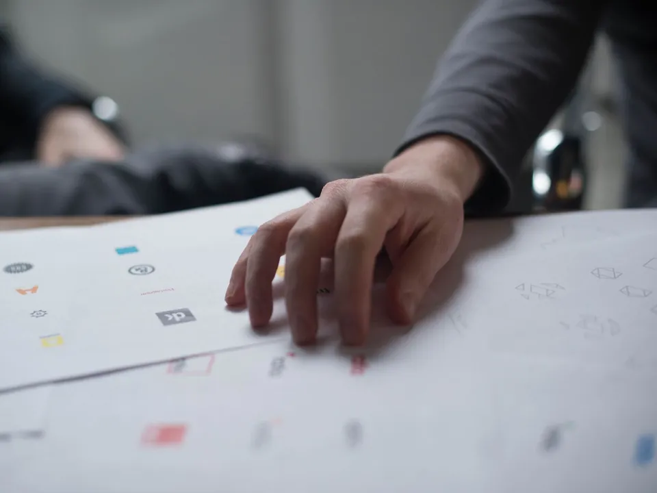 A designer reviewing real hand-drawn identity concepts