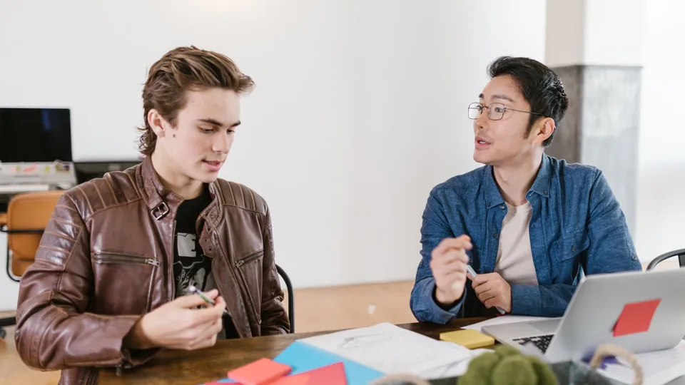 A real creative workshop, with two people reviewing ideas for a project